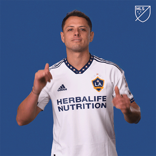 a man wearing a white herbalife nutrition shirt