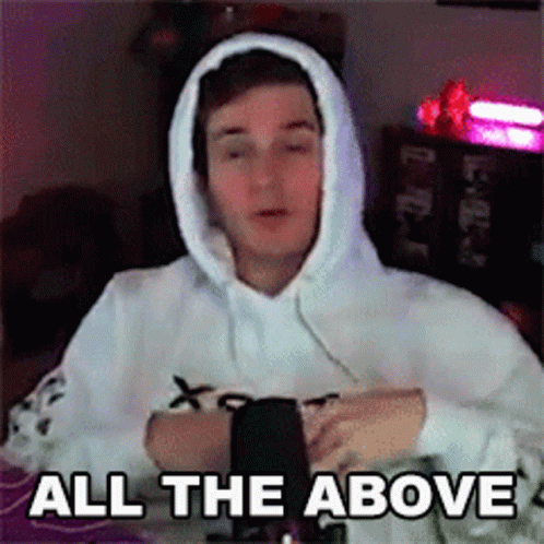 A Man Wearing A White Hoodie Is Sitting In Front Of A Microphone And Says `` All The Above '' . GIF