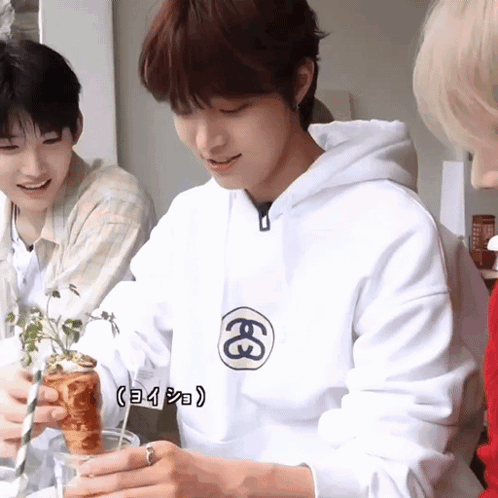A Man Wearing A White Hoodie With The Letter E On The Front GIF