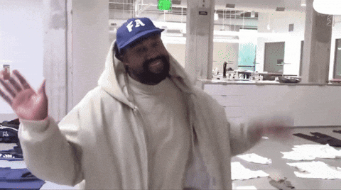 A Man Wearing A White Jacket And A Blue Hat With Fa On It GIF
