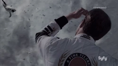 A Man Wearing A White Jacket That Says ' A Fine Pilsner ' On The Back GIF