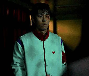 A Man Wearing A White Jacket With A Red Heart On It GIF