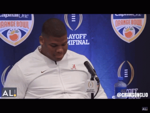 A Man Wearing A White Jacket With The Letters A On It GIF