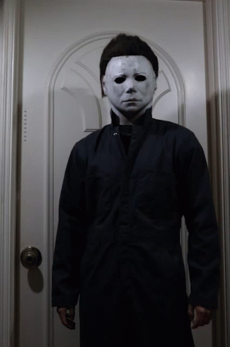 a man wearing a white mask and a black jacket