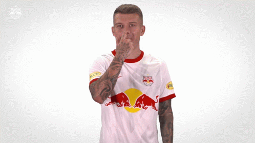 A Man Wearing A White Red Bull Jersey Making A Funny Face GIF