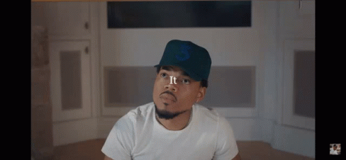 A Man Wearing A White Shirt And A Hat With The Number 3 On It GIF