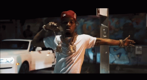 A Man Wearing A White Shirt And A Red Hat With The Letter G On It GIF