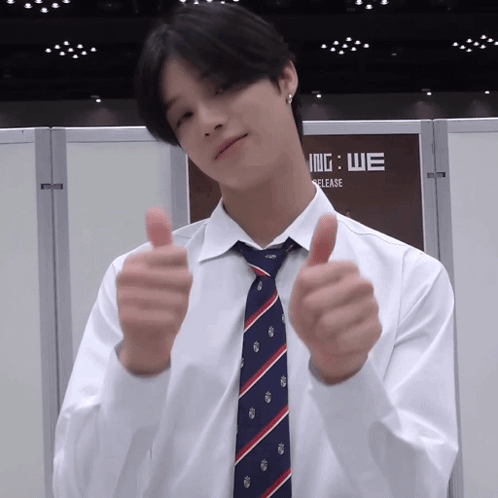 A Man Wearing A White Shirt And Tie Gives A Thumbs Up GIF
