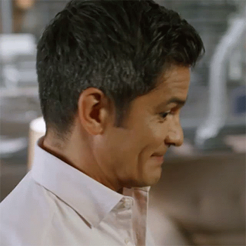 A Man Wearing A White Shirt Is Making A Funny Face GIF