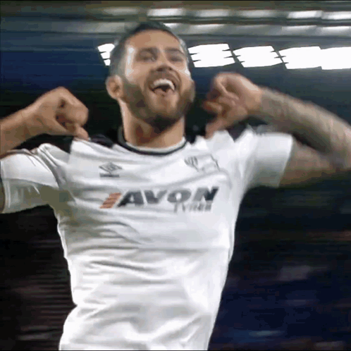 A Man Wearing A White Shirt That Says Avon Tyres GIF