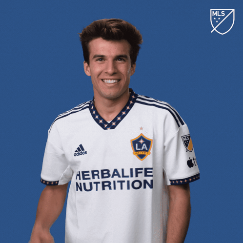 a man wearing a white shirt that says herbalife nutrition