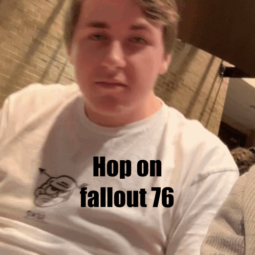 A Man Wearing A White Shirt That Says Hop On Fallout 76 On It GIF