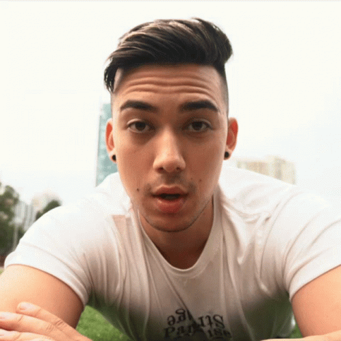A Man Wearing A White Shirt That Says Paradise GIF