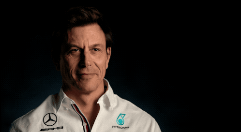 A Man Wearing A White Shirt That Says Petronas GIF