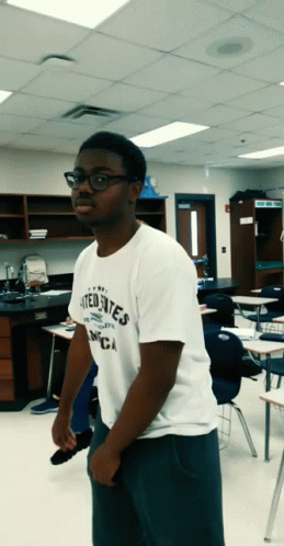 A Man Wearing A White Shirt That Says United States Of America GIF
