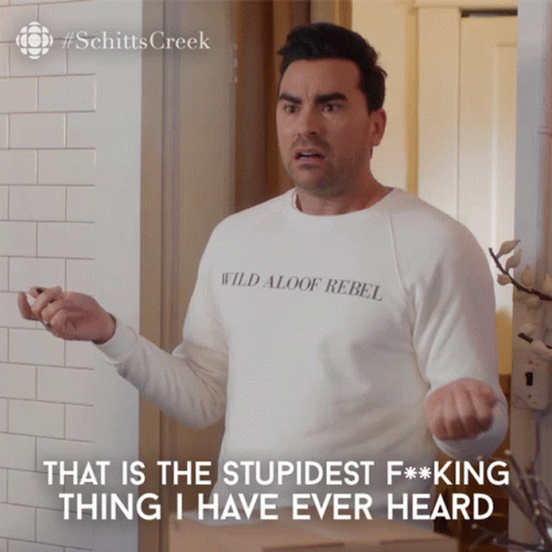 A Man Wearing A White Shirt That Says Wild Aloof Rebel On It GIF