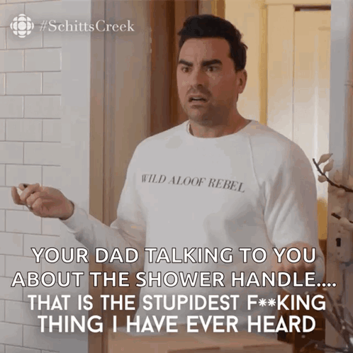 A Man Wearing A White Shirt That Says Wild Aloof Rebel On It GIF