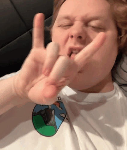 A Man Wearing A White Shirt With A Picture Of A Mountain On It Is Making A Funny Face GIF