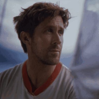 A Man Wearing A White Shirt With A Red Collar Looks Out A Window GIF