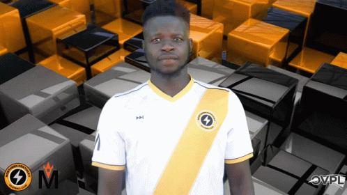 A Man Wearing A White Shirt With A Yellow Stripe And A Lightning Bolt On The Front GIF