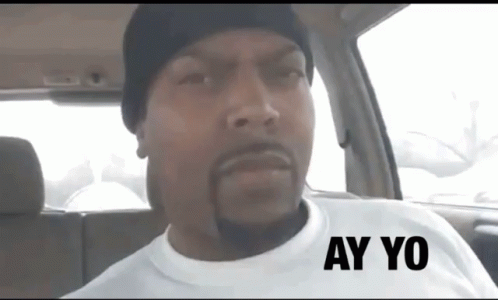 A Man Wearing A White Shirt With Ay Yo Written On It GIF