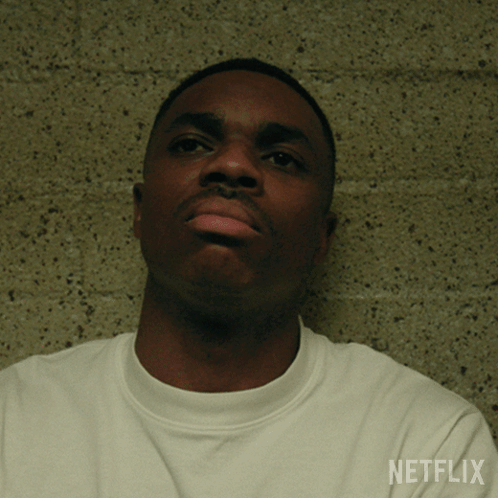 A Man Wearing A White Shirt With Netflix Written On The Sleeve GIF