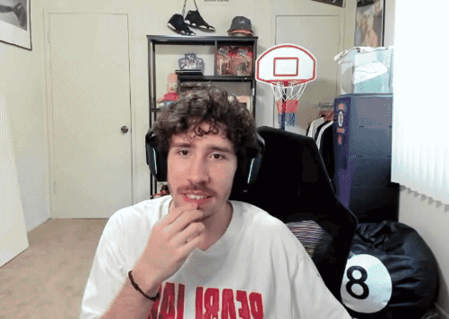 A Man Wearing A White Shirt With Red Letters That Says ' Miami ' On It GIF