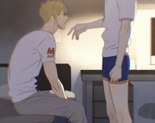 A Man Wearing A White Shirt With The Letter M On It Talks To Another Man GIF