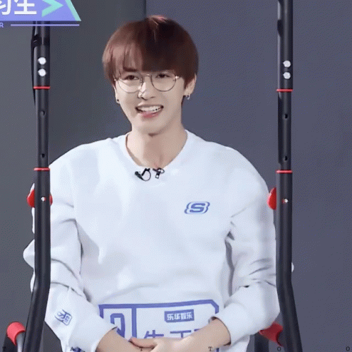 A Man Wearing A White Shirt With The Letter S On The Front GIF