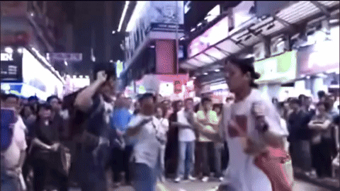 A Man Wearing A White Shirt With The Word Supreme On It Stands In Front Of A Crowd GIF