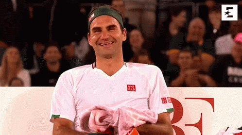 A Man Wearing A White Shirt With The Word Uniqlo On The Front GIF