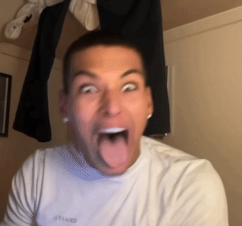 A Man Wearing A White Shirt With The Word United On It Sticks Out His Tongue GIF