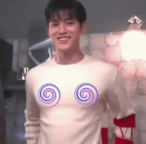 A Man Wearing A White Sweater With Two Spirals On It . GIF