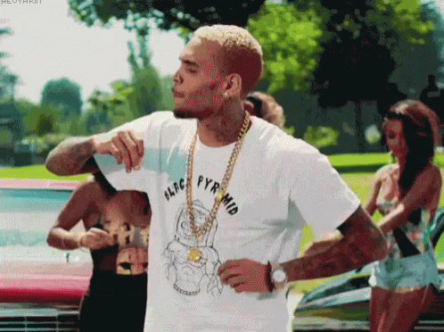 A Man Wearing A White T-Shirt That Says Aldc Pyrmid GIF