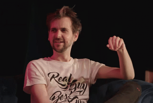 A Man Wearing A White T-Shirt That Says Real Guy On It GIF