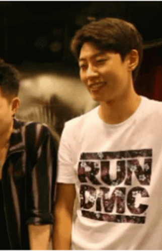 A Man Wearing A White T-Shirt That Says Run Emc GIF