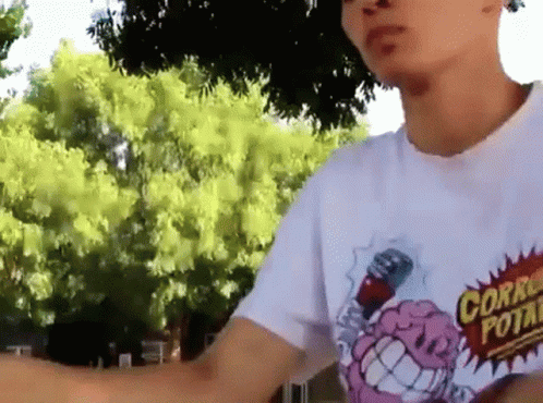 A Man Wearing A White T-Shirt With A Cartoon Brain On It GIF