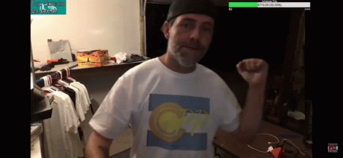 A Man Wearing A White T-Shirt With A Picture Of A Circle On It GIF