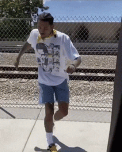 A Man Wearing A White T-Shirt With A Picture Of A Man On It GIF
