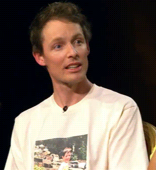 A Man Wearing A White T-Shirt With A Picture Of A Man On It GIF