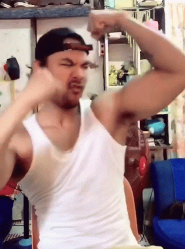 Man In White Tank Top And Cap Flexing GIF