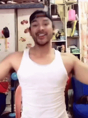 Man In White Tank Top And Baseball Cap Smiling GIF
