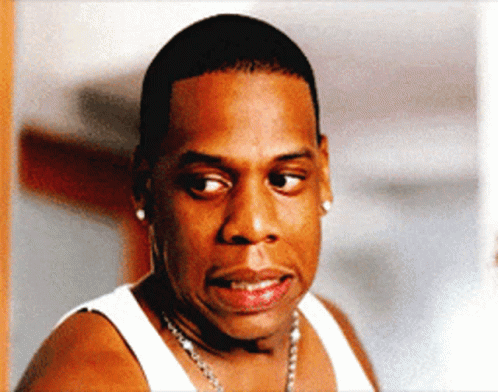 A Man Wearing A White Tank Top And A Necklace GIF