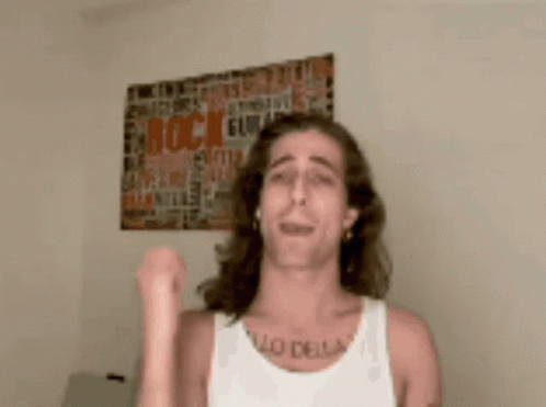 A Man Wearing A White Tank Top Has A Tattoo On His Chest That Says " Lo Della " GIF