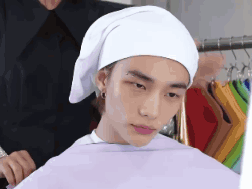 Man With White Towel Looks At Something GIF