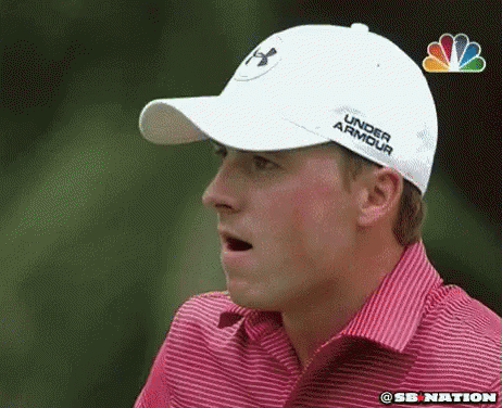 A Man Wearing A White Under Armour Hat Is Making A Funny Face GIF