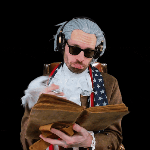 A Man Wearing A Wig And Headphones Is Reading A Book GIF