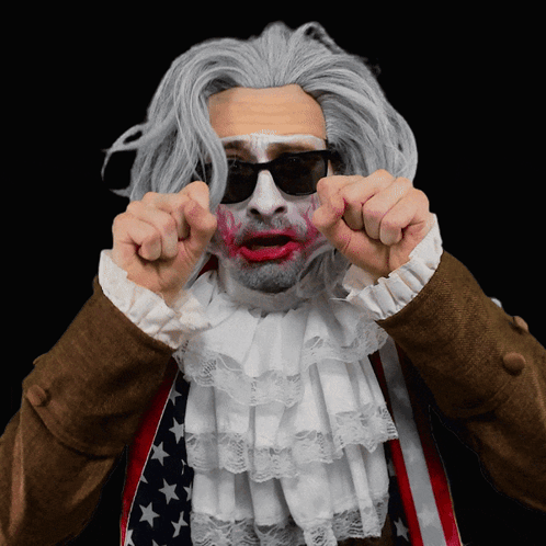 A Man Wearing A Wig And Sunglasses Has Red Lipstick On His Lips GIF