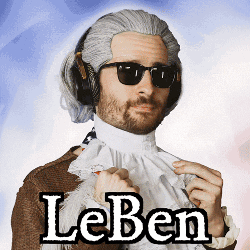 A Man Wearing A Wig And Sunglasses Has The Word Leben On His Shirt GIF