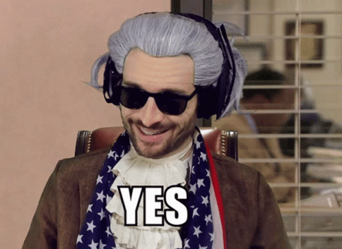 A Man Wearing A Wig And Sunglasses Has The Word Yes On His Chest GIF